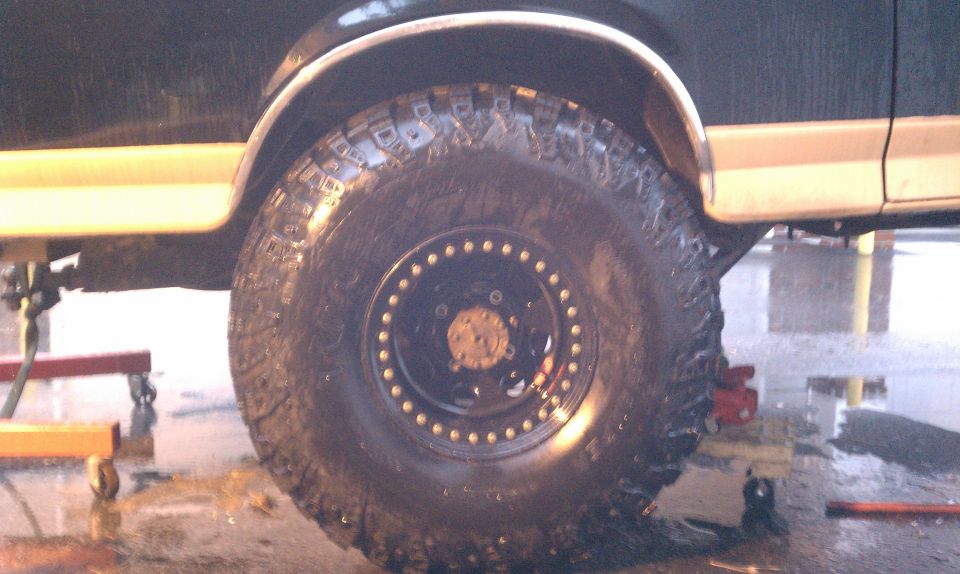 Side view of a vehicle's large off-road tire and fender