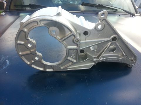 1994 Ford Bronco - A metal bracket is placed on the hood of a blue vehicle.