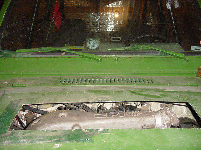 Green vehicle engine bay with EFI label visible on intake manifold