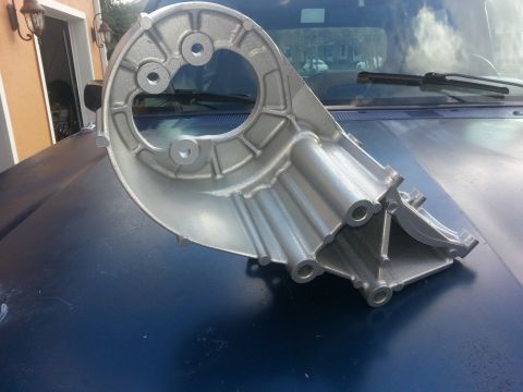 1994 Ford Bronco - Aluminum bracket part on car hood, likely for engine or accessory mounting.