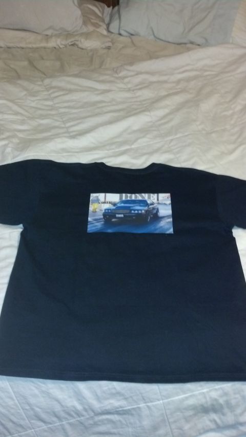 2003 Ford Crown Victoria - A t-shirt displays a printed image of a black car driving on a road.