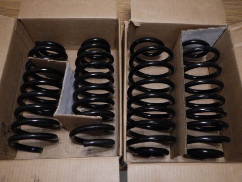 2003 Ford Crown Victoria - Four black coil springs, likely for suspension modification, are shown packaged in cardboard boxes.