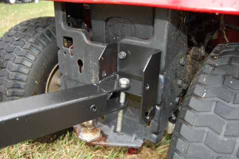 2006 Honda RANCHER - Close-up view of the rear hitch attachment on a red riding mower.