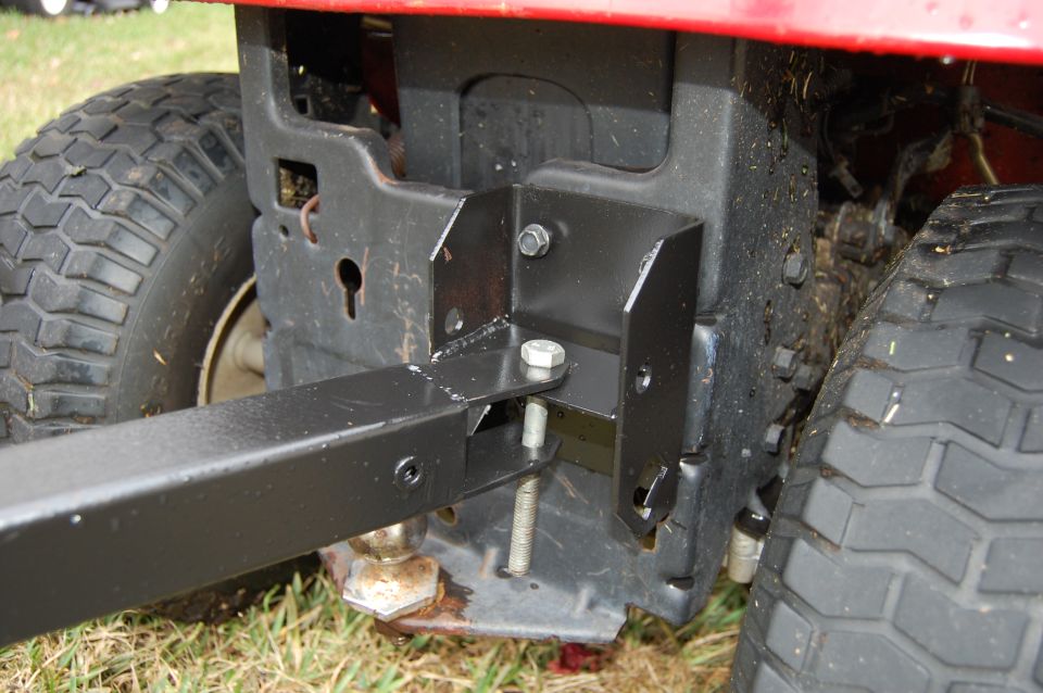 Rear hitch attachment on a red riding mower