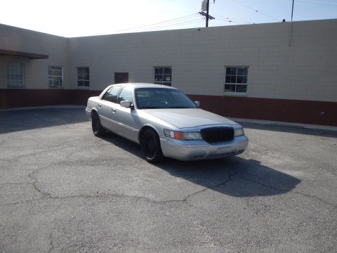 2002 Mercury Grand Marquis - A silver 2002 Mercury Grand Marquis sedan is parked in an outdoor lot.