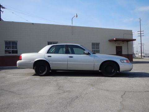 2002 Mercury Grand Marquis - Side profile of a silver 2002 Mercury Grand Marquis with black wheels parked outdoors.