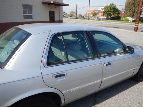 2002 Mercury Grand Marquis - Side view of a silver 2002 Mercury Grand Marquis sedan parked on a street.