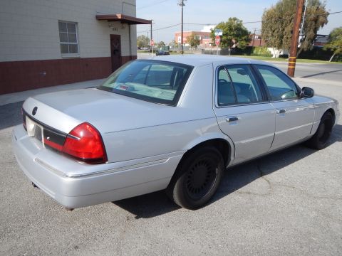 2002 Mercury Grand Marquis - A silver 2002 Mercury Grand Marquis sedan is seen from the rear quarter angle on a sunny day.