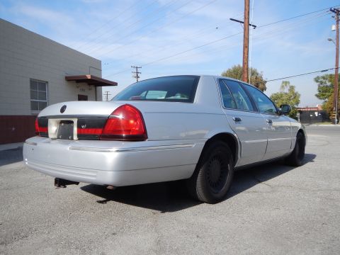 2002 Mercury Grand Marquis - Rear view of a silver 2002 Mercury Grand Marquis parked on asphalt.