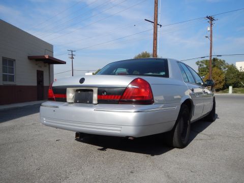 2002 Mercury Grand Marquis - Rear view of a silver 2002 Mercury Grand Marquis sedan parked on asphalt.