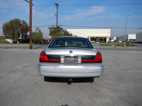 2002 Mercury Grand Marquis - Rear view of a silver 2002 Mercury Grand Marquis sedan parked in a lot.