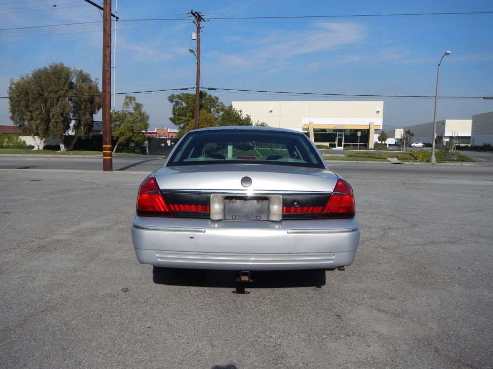 Silver 2002 Mercury Grand Marquis rear view. Tow hitch visible