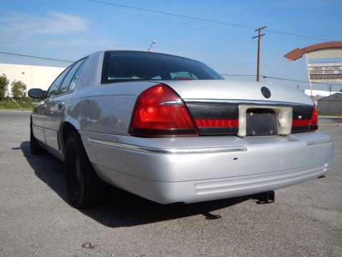 2002 Mercury Grand Marquis - Rear view of a silver 2002 Mercury Grand Marquis, its distinctive taillights and chrome accents.