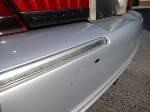 2002 Mercury Grand Marquis - Rear view of a silver Mercury Grand Marquis, showing the bumper and taillight assembly.