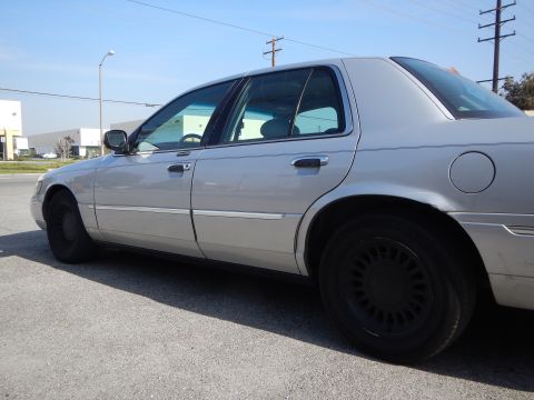 2002 Mercury Grand Marquis - Side profile of a silver 2002 Mercury Grand Marquis sedan parked on asphalt.