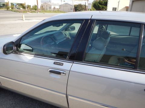 2002 Mercury Grand Marquis - The driver's side of a silver 2002 Mercury Grand Marquis is shown, revealing the interior and door keypad.