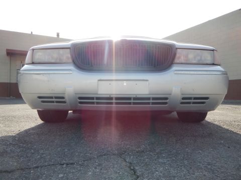 2002 Mercury Grand Marquis - Silver 2002 Mercury Grand Marquis front end with grille and headlights visible.