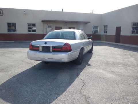 2002 Mercury Grand Marquis - Rear view of a silver 2002 Mercury Grand Marquis parked on asphalt.