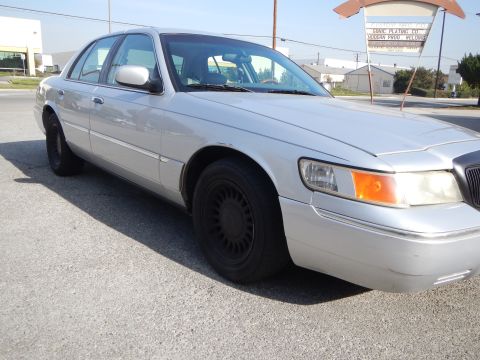 2002 Mercury Grand Marquis - A silver 2002 Mercury Grand Marquis sedan is viewed from the front three-quarter angle on a sunny day.