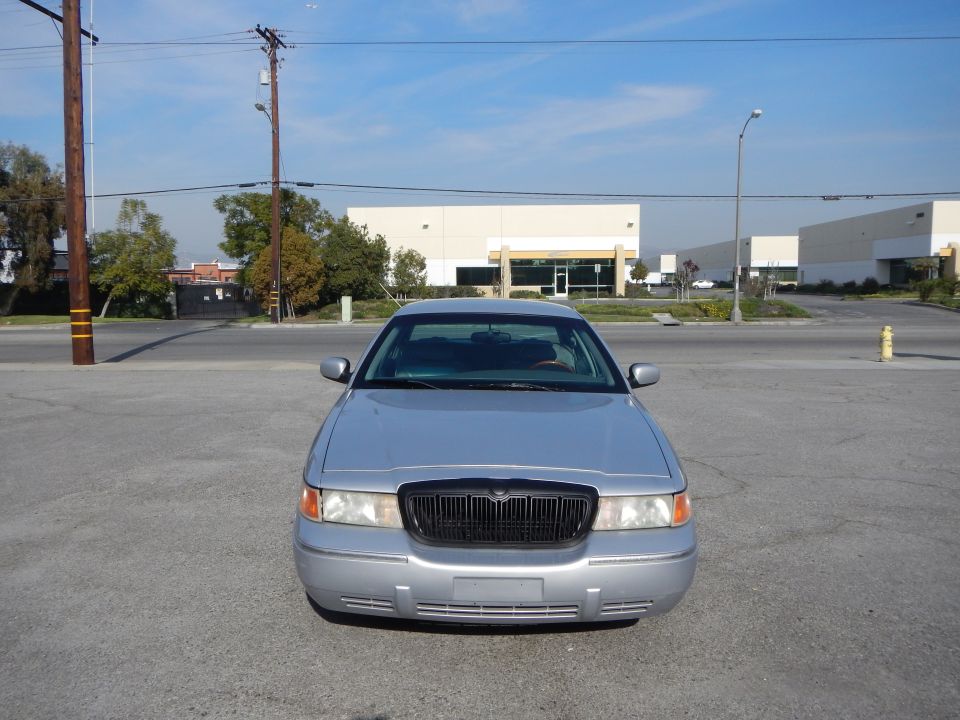 Silver 2002 Mercury Grand Marquis with black grille, parked outdoors
