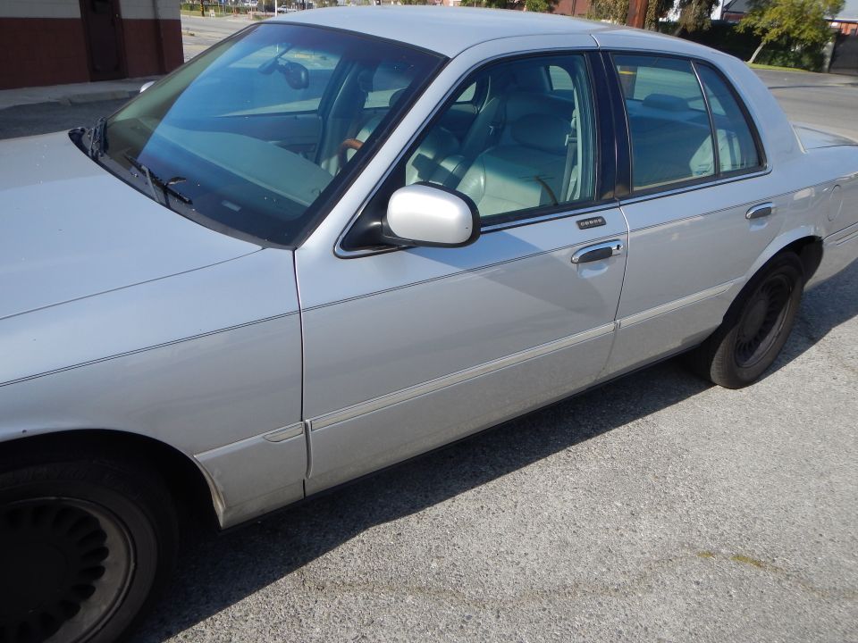 Silver 2002 Mercury Grand Marquis sedan, side view