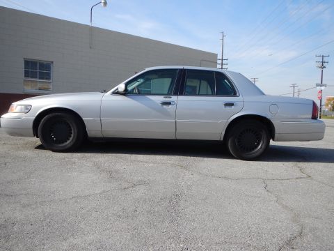2002 Mercury Grand Marquis - Side profile of a silver 2002 Mercury Grand Marquis sedan parked outdoors.