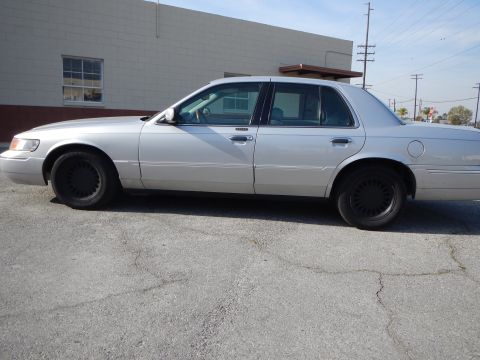 2002 Mercury Grand Marquis - Side view of a silver 2002 Mercury Grand Marquis parked on asphalt.