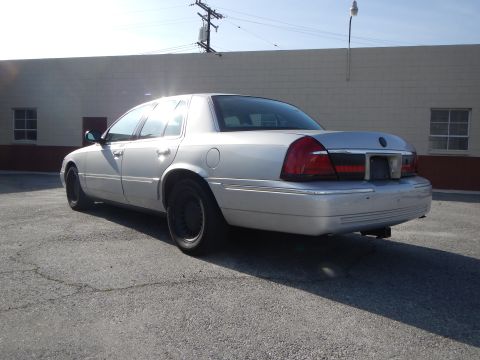 2002 Mercury Grand Marquis - Rear 3/4 view of a silver 2002 Mercury Grand Marquis parked outdoors.