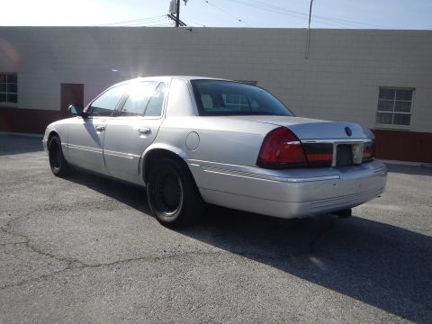 2002 Mercury Grand Marquis - Silver 2002 Mercury Grand Marquis parked outdoors with a building in the background.