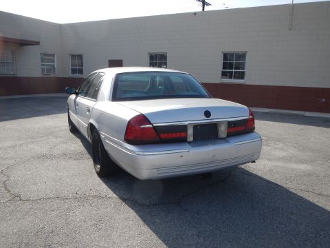 2002 Mercury Grand Marquis - Rear view of a silver 2002 Mercury Grand Marquis parked on asphalt.