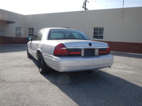 2002 Mercury Grand Marquis - Rear view of a silver 2002 Mercury Grand Marquis sedan parked outdoors.