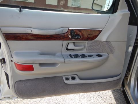 2002 Mercury Grand Marquis - Interior door panel details for a 2002 Mercury Grand Marquis, including wood trim and control buttons.