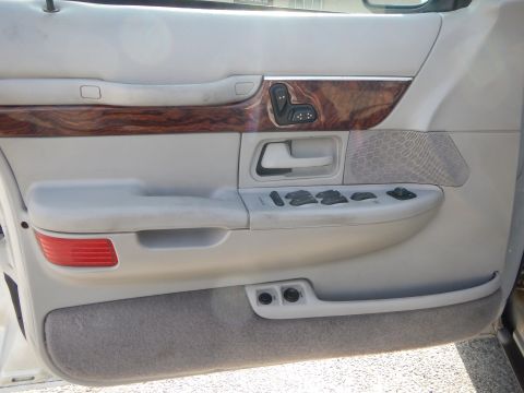 2002 Mercury Grand Marquis - Interior view of the driver's side door panel, wood grain trim and power controls.
