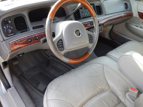 2002 Mercury Grand Marquis - Dashboard and interior of a 2002 Mercury Grand Marquis, wood trim and leather seats.