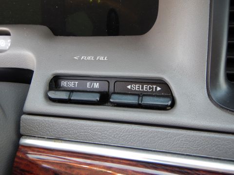2002 Mercury Grand Marquis - Close-up of dashboard controls, including fuel fill indicator and buttons for reset and select functions.