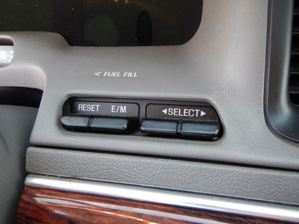 Interior dashboard with 'FUEL FILL' indicator and 'RESET E/M' and 'SELECT' buttons