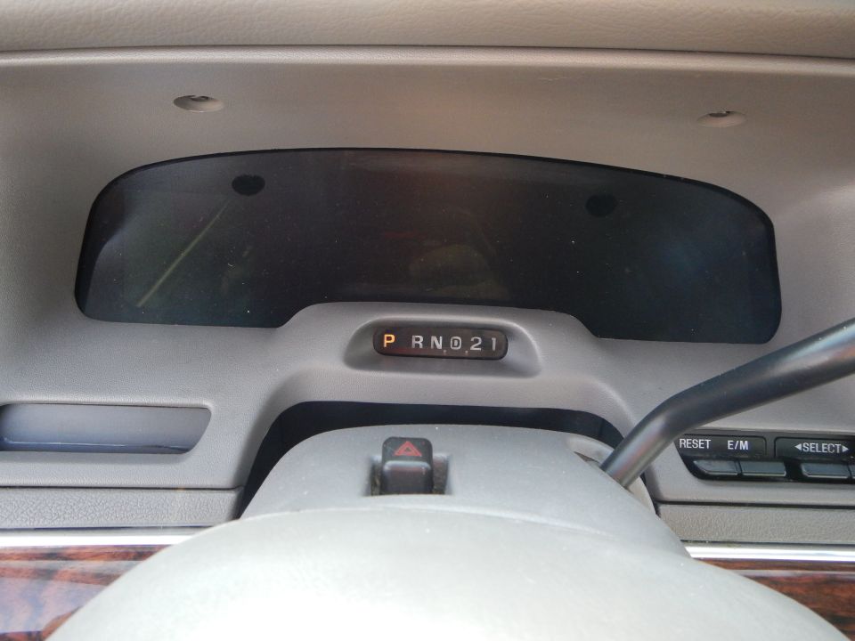 Interior dashboard of a 2002 Mercury Grand Marquis showing PRND21 gear indicator
