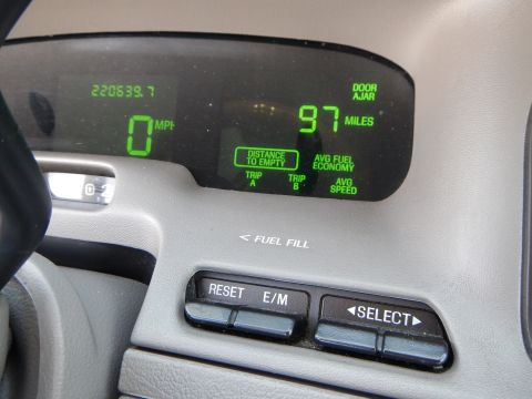 2002 Mercury Grand Marquis - Dashboard display shows odometer, speed, and fuel range information. Door ajar warning is also visible.