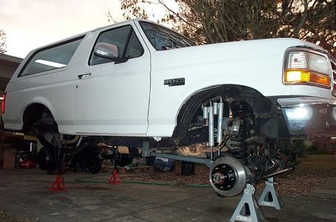 1995 Ford Bronco - This 1995 Ford Bronco is undergoing suspension modifications, with its wheels removed and lifted on jack stands.