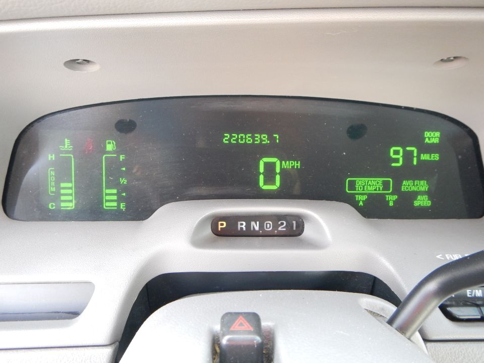 Digital dashboard showing odometer at 220639.7 miles, 0 MPH, fuel and temperature gauges, and trip computer data