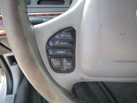2002 Mercury Grand Marquis - Close-up of the steering wheel interior in a 2002 Mercury Grand Marquis, showing cruise control buttons.