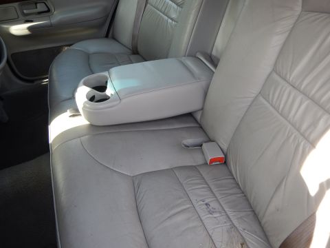 2002 Mercury Grand Marquis - Interior view of car's rear seats and center armrest with cup holders.