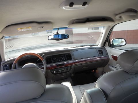 2002 Mercury Grand Marquis - Interior view of a 2002 Mercury Grand Marquis, wood grain accents on the dashboard and center console.