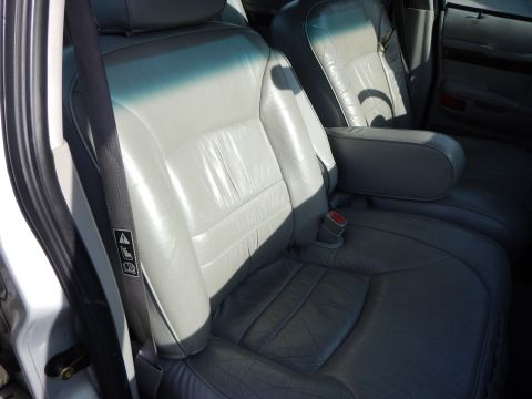 2002 Mercury Grand Marquis - Interior view of car's front seats and armrest.