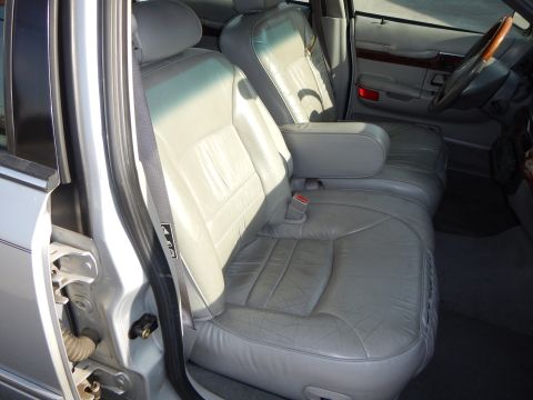 2002 Mercury Grand Marquis - The interior of a 2002 Mercury Grand Marquis features gray leather seats and wood trim accents.