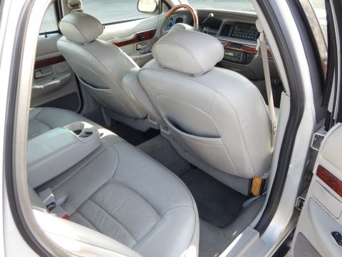 2002 Mercury Grand Marquis - The interior of a 2002 Mercury Grand Marquis is visible, with a focus on the rear seating area and dashboard details.