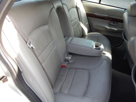 2002 Mercury Grand Marquis - Interior view of car's rear seating area, showing leather seats and armrest.