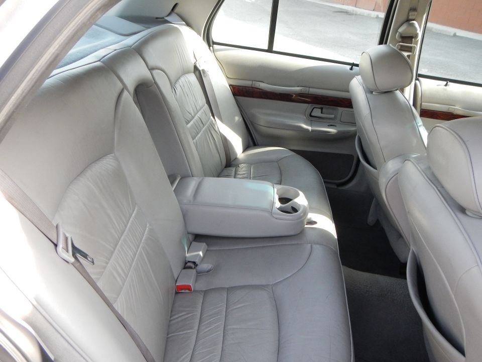 Interior shot of a 2002 Mercury Grand Marquis showing the rear leather seats and armrest