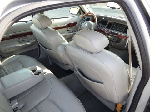 2002 Mercury Grand Marquis - Interior of a 2002 Mercury Grand Marquis, leather seats and wood grain accents on the dashboard.