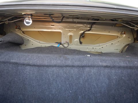 2002 Mercury Grand Marquis - The interior of a car's trunk, showing the carpeted floor and the metal structure behind it.